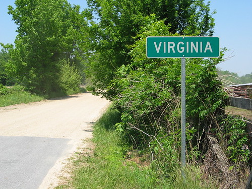 An unpaved gravel road running through open rural countryside