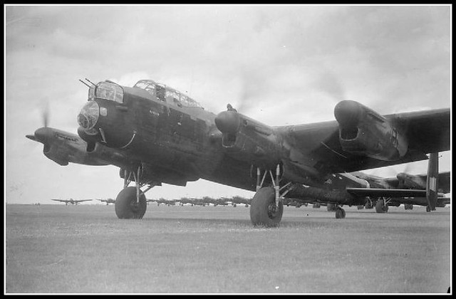 Avro Lancaster B Mark I, R5620 'OL-H', of No 83 Squadron RAF, leads the queue of aircraft waiting to take off from Scampton, Lincolnshire, on the 'Thousand-Bomber' raid to Bremen, Germany. R5620, flown by Pilot Officer J R Farrow and his crew, was the onl