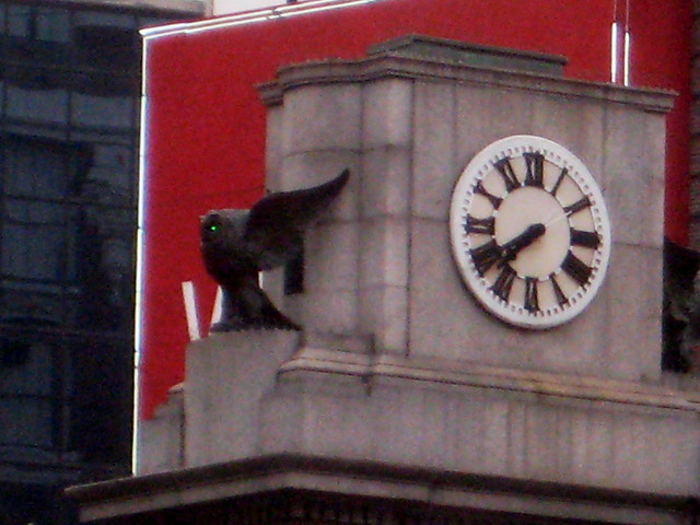 The Owls are not what they seem - Herald Square Clock Owls with Glittering Green Evening Eyes NYC 7899