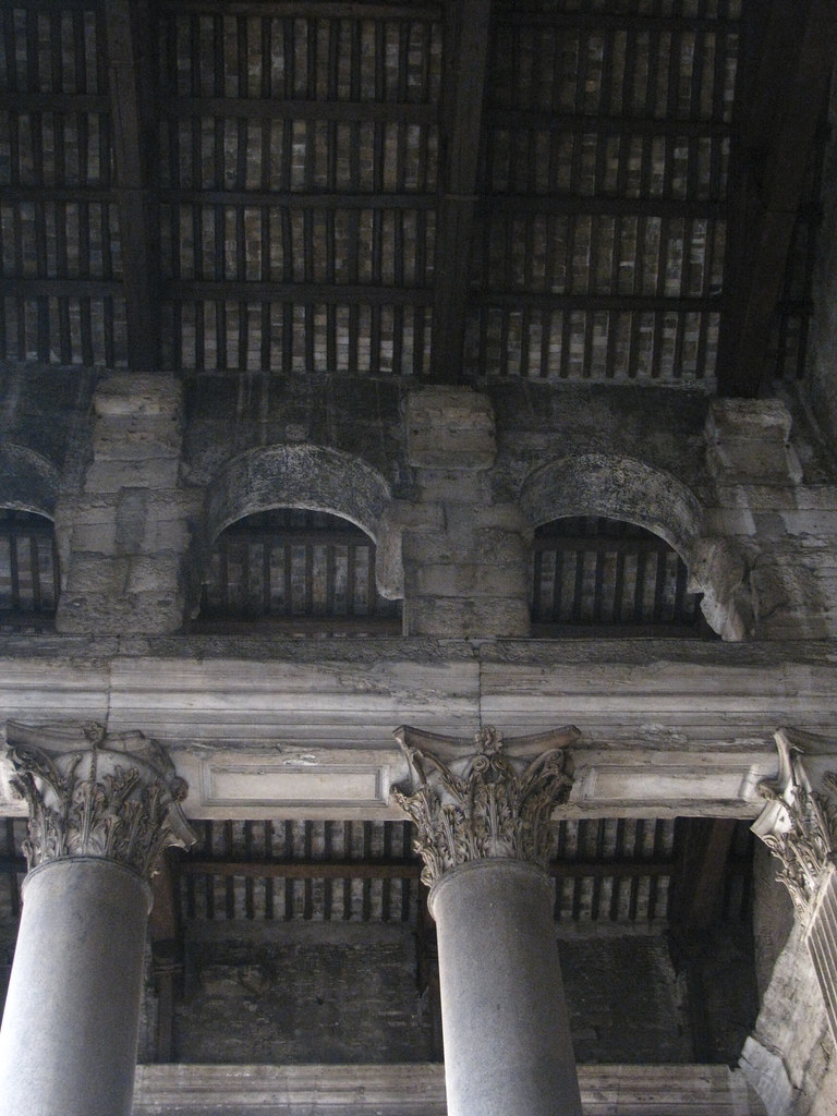 The Pantheon (IX) ceiling shown from the bottom up. There are two arches depicted and columns that sit below them. 
