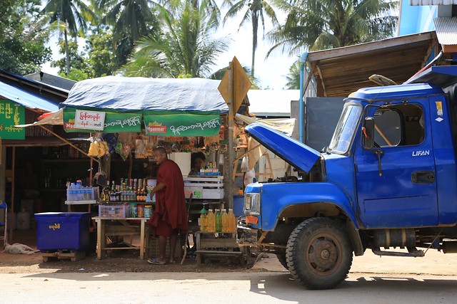 Monk at Road side stall Blue Truck Burma Myanmar
