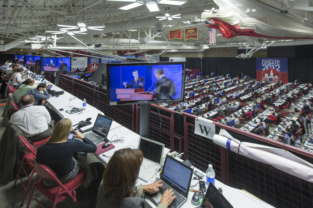 Journalists watch the Oct. 3, 2012, presidential debate and file stories from the media filing center across from the debate hall at the University of Denver.