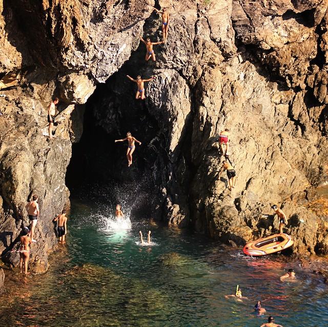 Adreline jump for the local kids at the cave in Monterosso