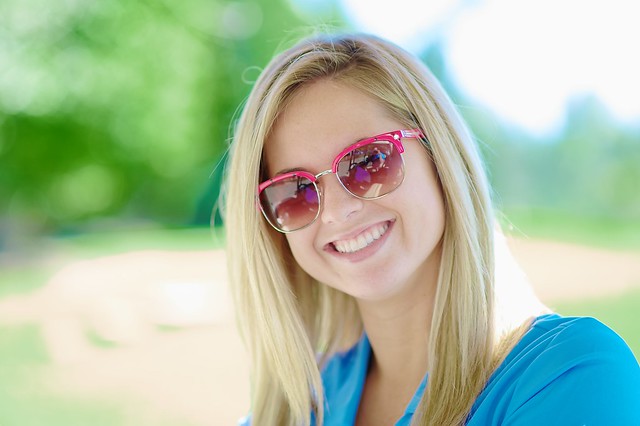 A smile, colorful sunglasses + lots of smooth bokeh