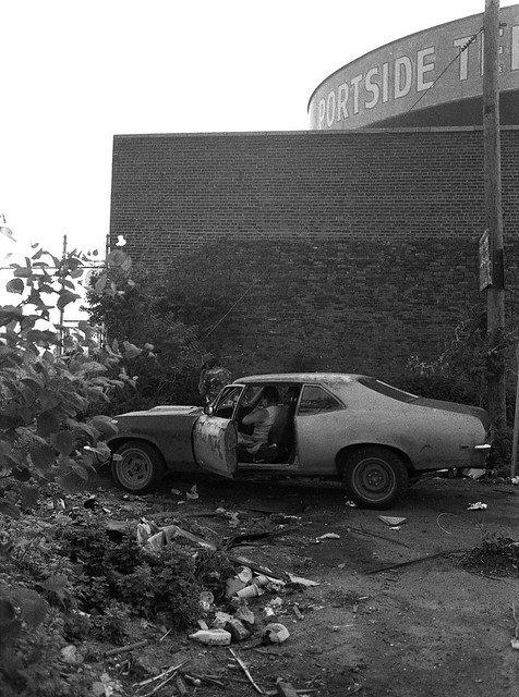 The good old days in Jersey City. The leaking gasoline tanks of Portside Terminal right on the Morris Canal. A guy sits in his old beat up Chevy Nova with mismatched rims and differently colored body panels amidst a pile of garbage and weeds. August 1981