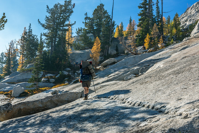 Backpacker Crossing Expanse of Granite along Trail into The Enchantments