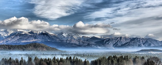 Clouds above mountains with fog