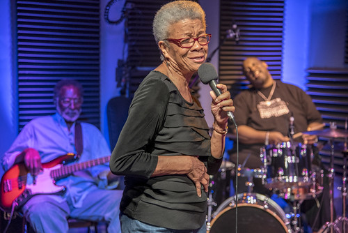 Germaine Bazzle at WWOZ. George and Gerald French in the background. Photo by Marc PoKempner.