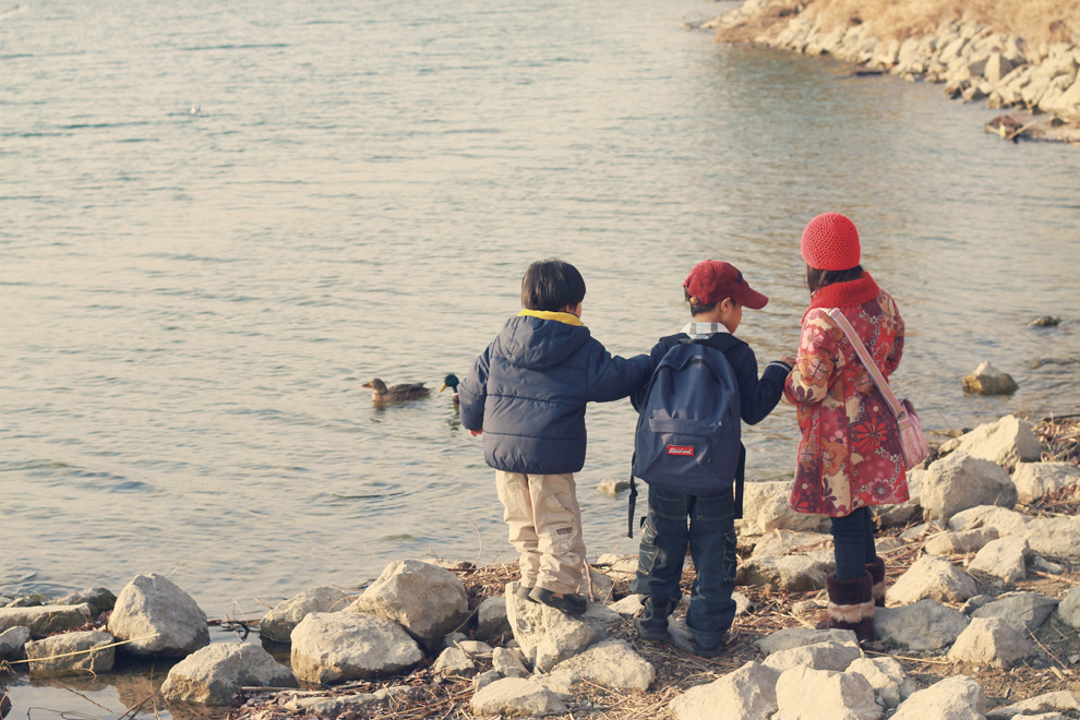 Photographing Kids For This Mother's Memory Bank, siblings by the danube river on a warm winter day observing ducks