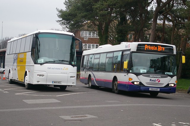13-036 Rail replacement bus services at Bournemouth - one of two; First Hants and Dorset  Scania Omnicity 65007 (YN54 NZC) passes 'Just Go Holiday' liveried Pewsey Vale VDL Bova Futura (WA11 AEC)