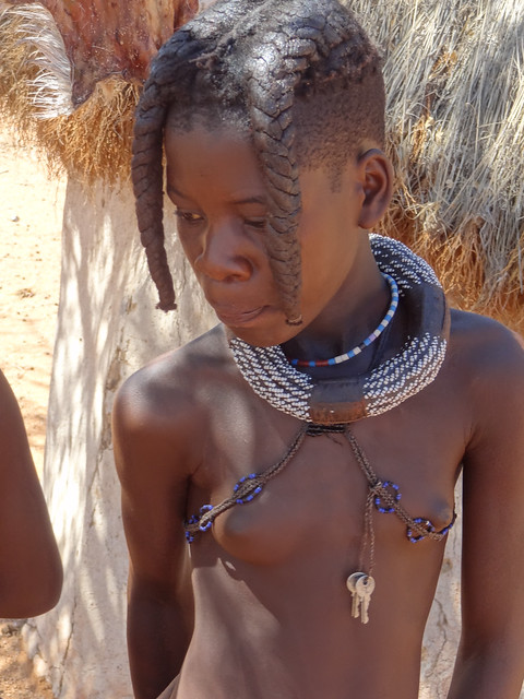 Girl With Keys, Traditional Jewelry and Two Plaited Hair Worn Forward (Hair Style Determined by Age), Otjikandero Himba Village, Kunene, Namibia (HDR)