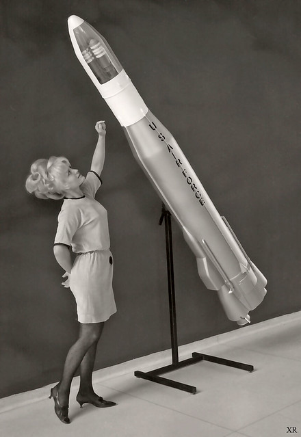 ... woman with model of Atlas ICBM
