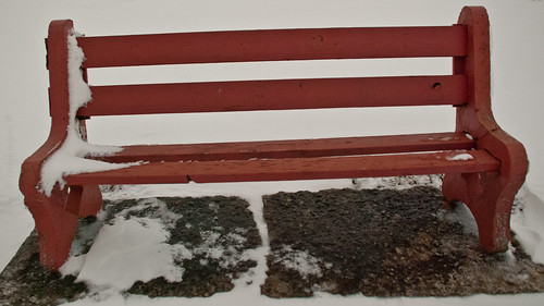 red snow bench concrete