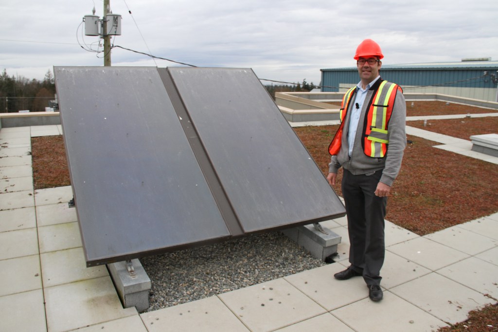 Chris Midgley on the green roof with solar thermal panels at the Leed Gold Church Road Transfer Station