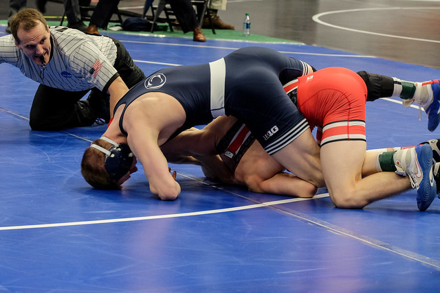 Jason Nolf has a leg in on the left side and a half-nelson on the right side