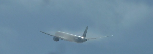 Cathay Pacific B-KTP Boeing 777-367ER jet climbs into the clouds above LAX
