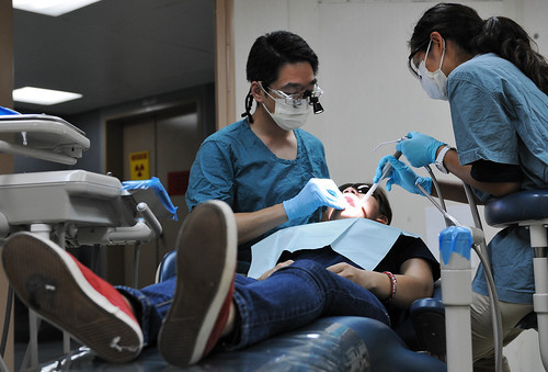 A dentist performs a root canal.