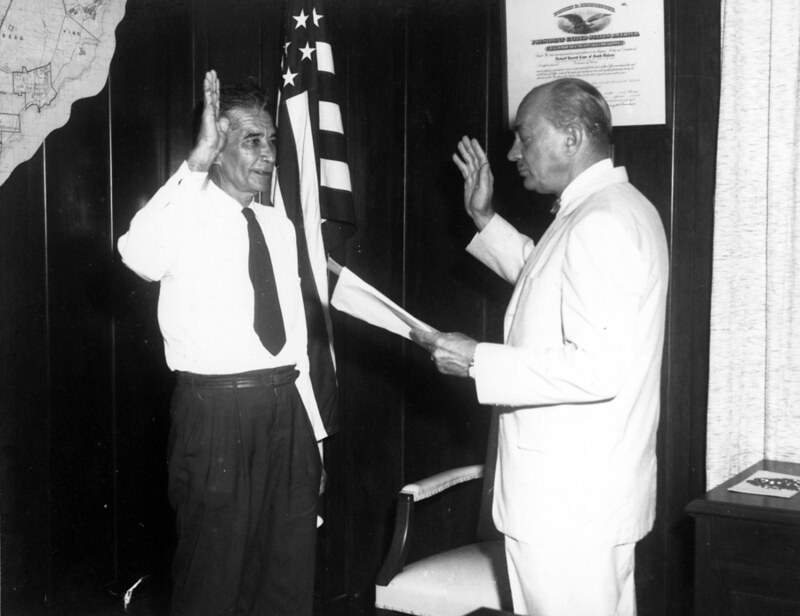 Governor Richard Barrett Lowe, Governor of Guam from 1956 – 1959, swearing in unidentified man. Guam Police Official Photograph and courtesy of the Micronesian Area Research Center (MARC).
