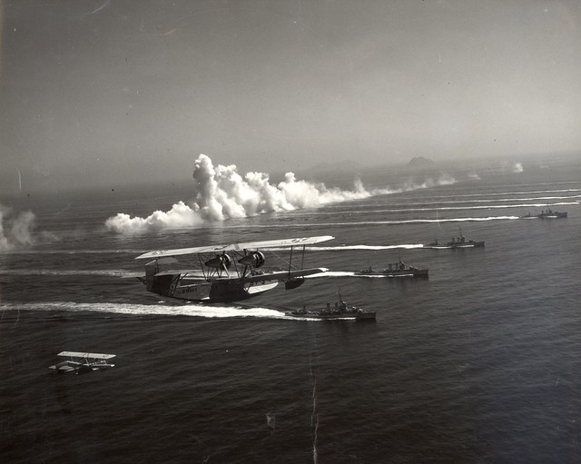 Martin PM-1 passing over a squadron of destroyers
