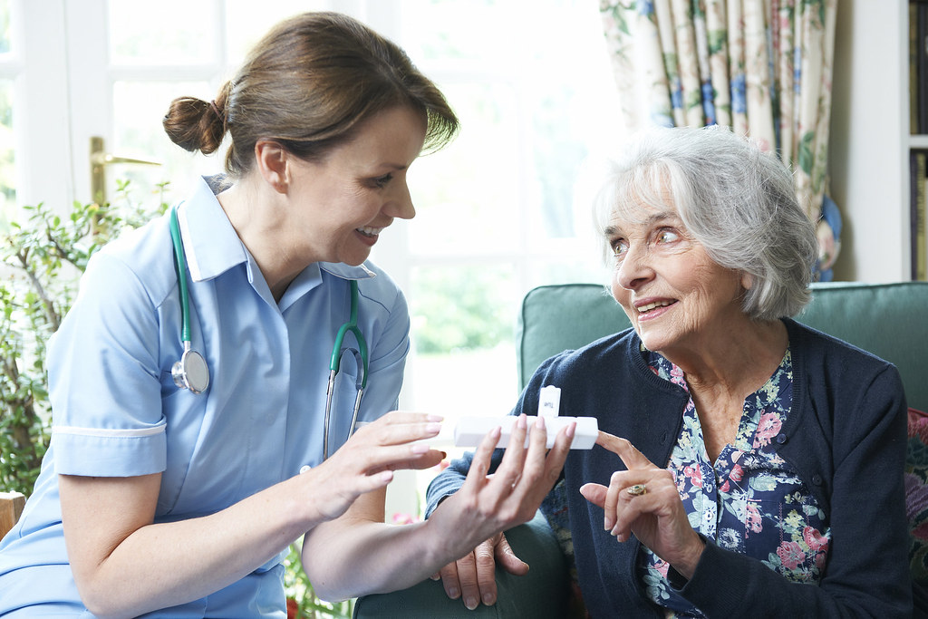 Nurse Advising Senior Woman On Medication At Home | Nurse Ad… | Flickr