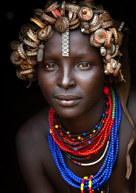 Portrait Of A Young Dassanech Woman Wearing Bottle Caps Headgear And Beaded Necklaces Omo Valley Ethiopia