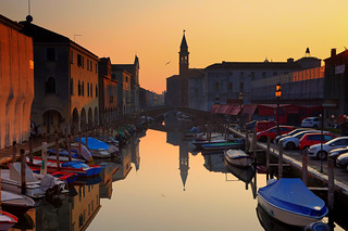 Ponte Filippi over the canal of Chioggia and St James church during the sunset