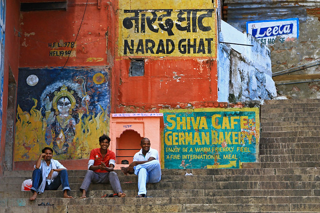 Three men sitting on the ghats in Varanasi, India.