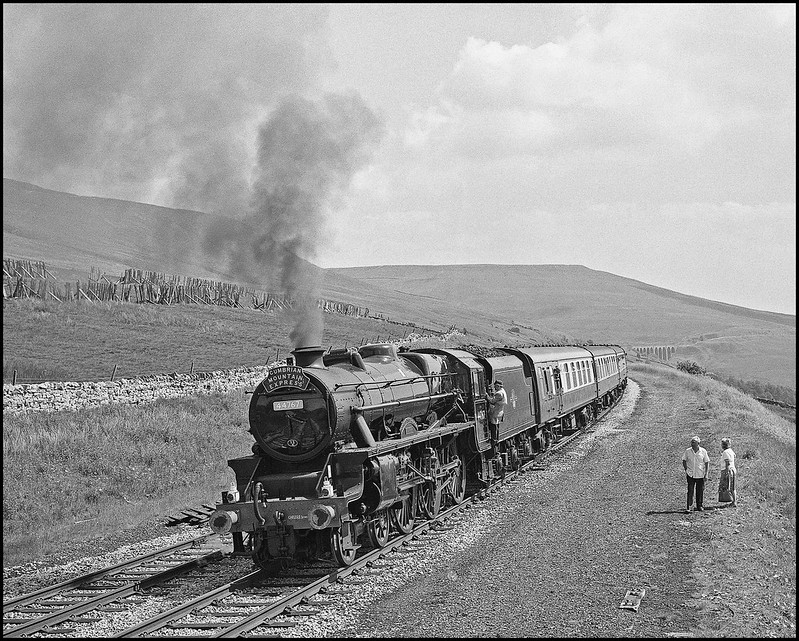 With its smokebox number plate already painted a light blue background ( ScR ) 44767 uses a midweek SLOA CME  as part of its passage to Fort William to join 5407 for the innaugural season of West Highlander operations. This appeared to be an unsheduled brief stop here, and a pleasant surprise to the two tourists on holiday in the Dales.