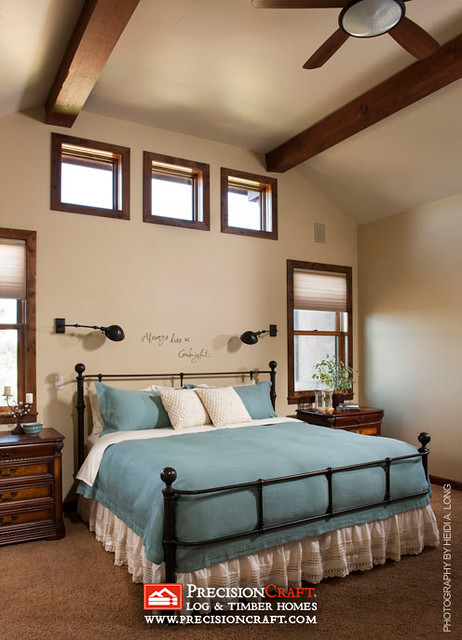 Master Bedroom in this Custom Timber Frame Home by PrecisionCraft