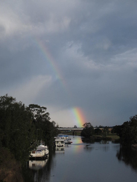 Boats and rainbow on river