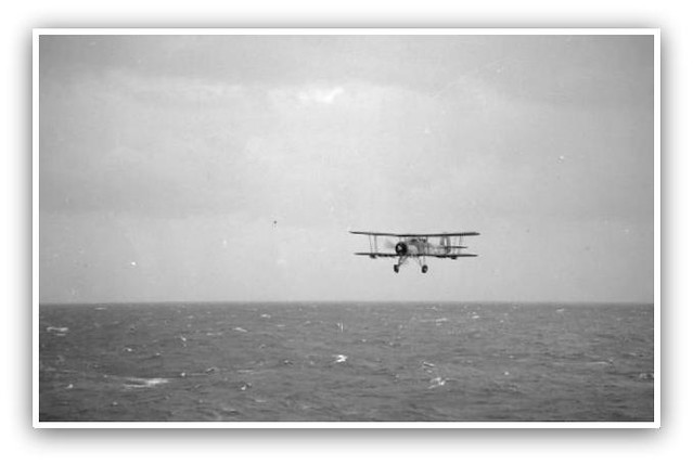 A Fairey Swordfish from the aircraft carrier HMS ARK ROYAL returns at low level over the sea after making a torpedo attack on the German battleship BISMARCK.