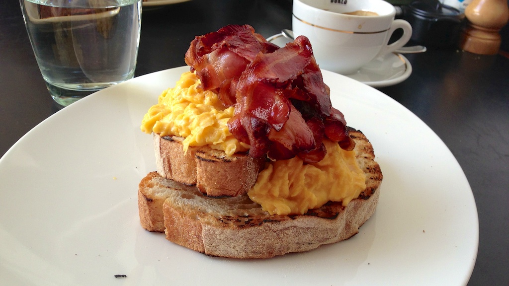 Scrambled eggs on toast with bacon at Speakeasy Kitchen