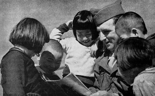 AMBASSADORS OF GOODWILL: AMERICAN GI TALKING WITH CHILDREN IN JAPAN 1945