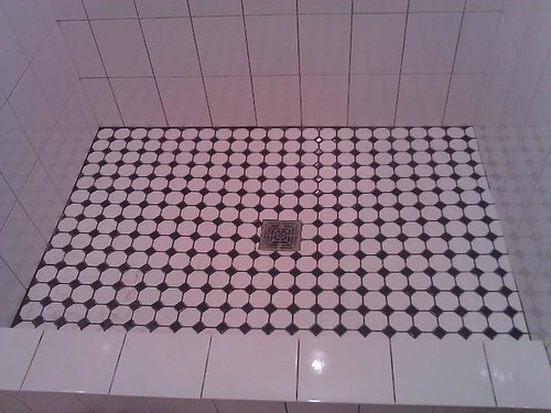 Ceramic tile shower with marble mosaic base