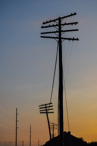 fading transmissions power lines utility pole electric wires silhouette blue hour sunset twilight sky evening london ohio small town railroad depot roof clouds minimalism