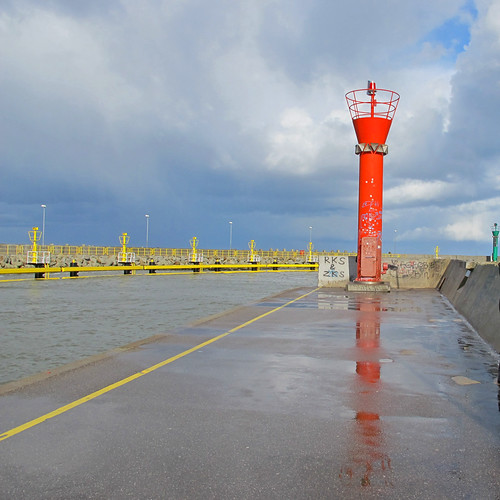 Red lighthouse reflected | by Rosmarie Wirz