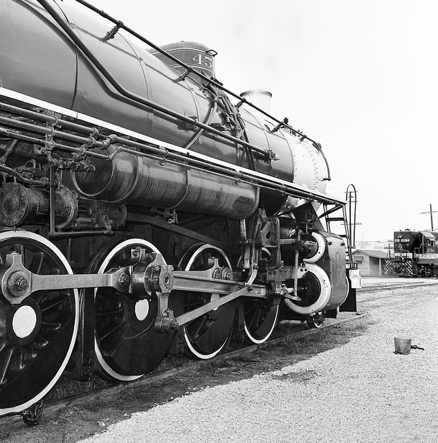 Southern Railway coal fired steam locomotive # 4501, Ms class Baldwin 2-8-2 Mikado, is seen in the Simpson Railroad Yard where the older meets the newer EMD GP38 diesel electric locomotive # 2794, at Jacksonville, Florida, early 1970's