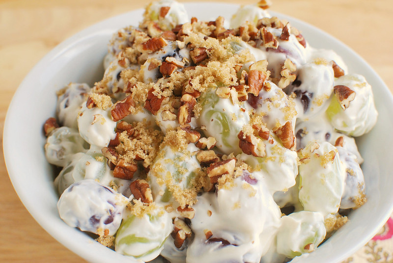 Grape Salad - red and green grapes tossed in a sweet creamy sauce and topped with brown sugar and pecans! This is so delicious and perfect for summer parties!