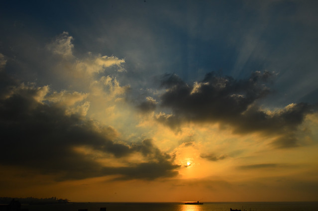 Sunset over the gulf of Beirut with rays piercing the clouds