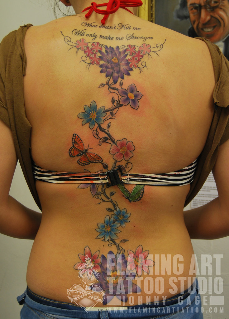 flowers up spine tattoo