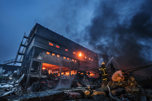 Firefighters before daybreak at Tampaco Foil Ltd.