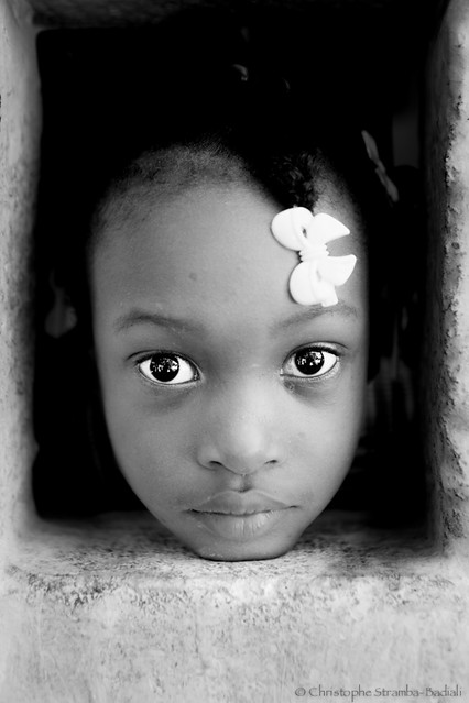Haitian schoolgirl behind the wall of school - AYITI - .