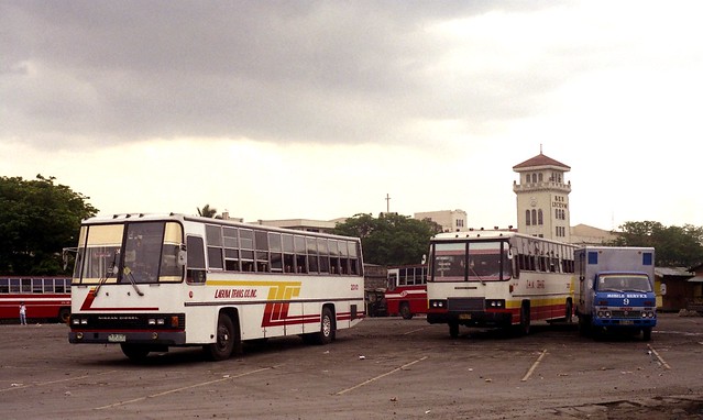 23749 (584) 11-03-1990 Laguna Trans Nissan (fleet No 2010) and J.A.M Trans Nissan DVB-13x in the Lawton layover area of Manila, Philippines.