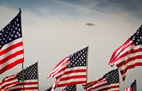 Space Shuttle Endeavour traveling to Los Angeles past 9-11 flag display