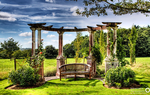 Beautiful Pergola at the bottom of the Garden at Hill Place, Swanmore.  The grandparents of the current custodians are buried under the Pagoda as they wanted to be together in their favourite place.  Hill Place is a grade II listed[ Georgian country villa located near the village of Swanmore in Hampshire, England.
Richard Goodlad built Hill Place in about 1790. It is thought that Sir John Soane was the architect 
In 2011, Hill Place was the subject of a Channel 4 television documentary presented by hotelier Ruth Watson as part of her Country House Rescue series.  Focal Length: 21 mm
ISO Speed: 200
Aperture: f/11
Shutter Speed: 1/400 sec
