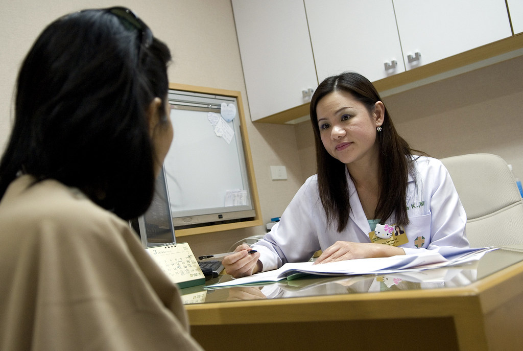 doctor consultation | A female doctor talks to a patient at … | Flickr
