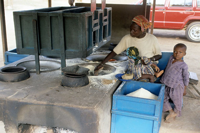 Woman frying gari