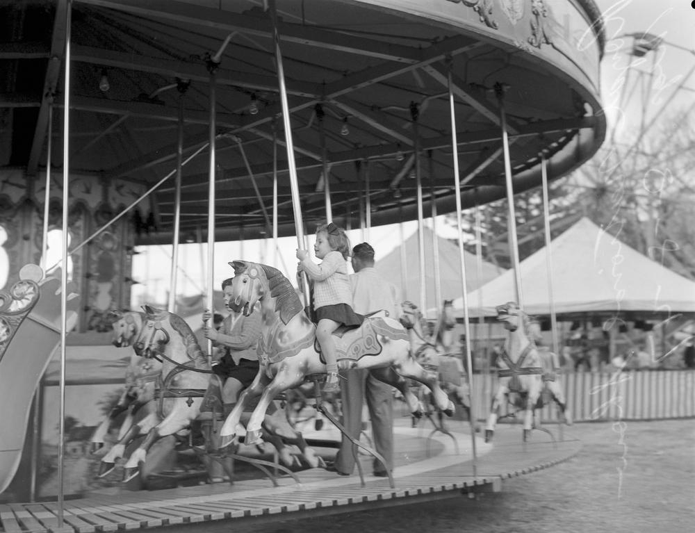 Children ride a carousel at the Brisbane Exhibition 1947