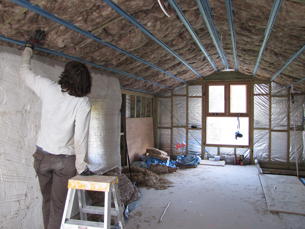 Installer working in an attic roof