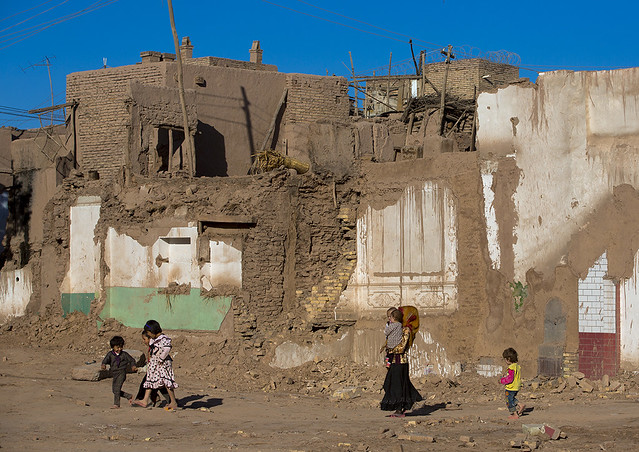 Family passing in the Demolished Old Town Of Kashgar, Xinjiang Uyghur Autonomous Region, China